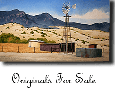 A windmill in the middle of an empty desert.